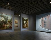 Four grand panels of Fragonard’s series The Progress of Love are shown together at Frick Madison in a gallery illuminated by one of Marcel Breuer’s trapezoidal windows. This view shows two of the 1771–72 paintings, with two later overdoors visible in the next gallery.