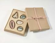 Genesis Belanger ceramic sculpture of a box of chocolate with facial features instead of chocolates