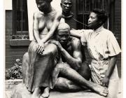 Augusta Savage posing with her sculpture Realization, created as part of the Works Progress Administration's Federal Art Project. Photo by Andrew Herman, circa 1938. Wikimedia Commons