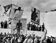 DAVID SEYMOUR black and white photograph of a crowd of people with their fists raised in the air