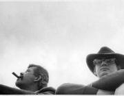 John Chamberlain and Larry Bell at the motorcycle races, Bridgehampton NY,1966. black and white, only their heads are visible