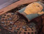 One of the mummies within a sarcophagus recently excavated from the newly discovered cemetery at Tuna al-Gebel in central Egypt.