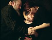 two parents cradle their child who has had a face transplant