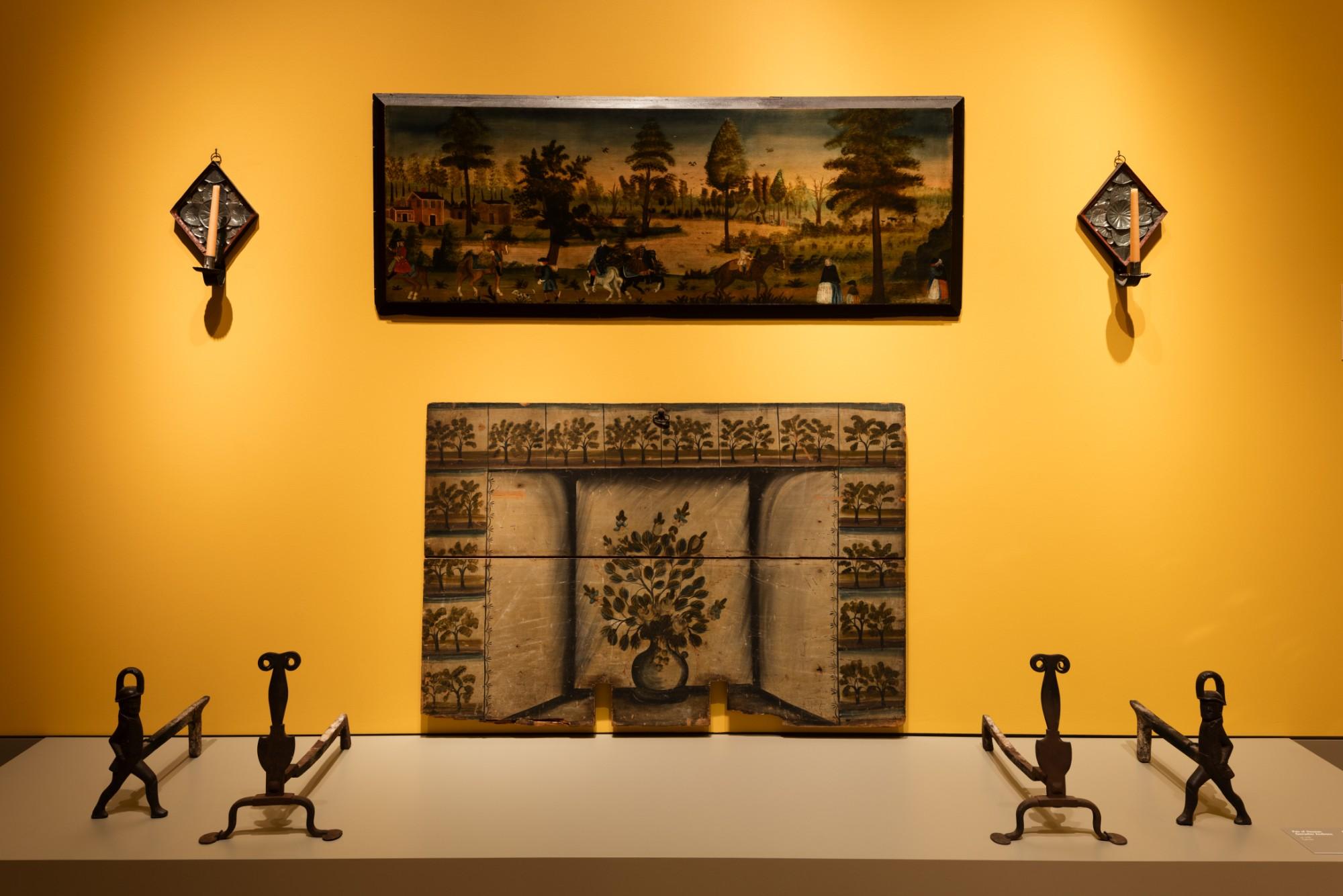 folk art gallery with a yellow wall and iron pieces