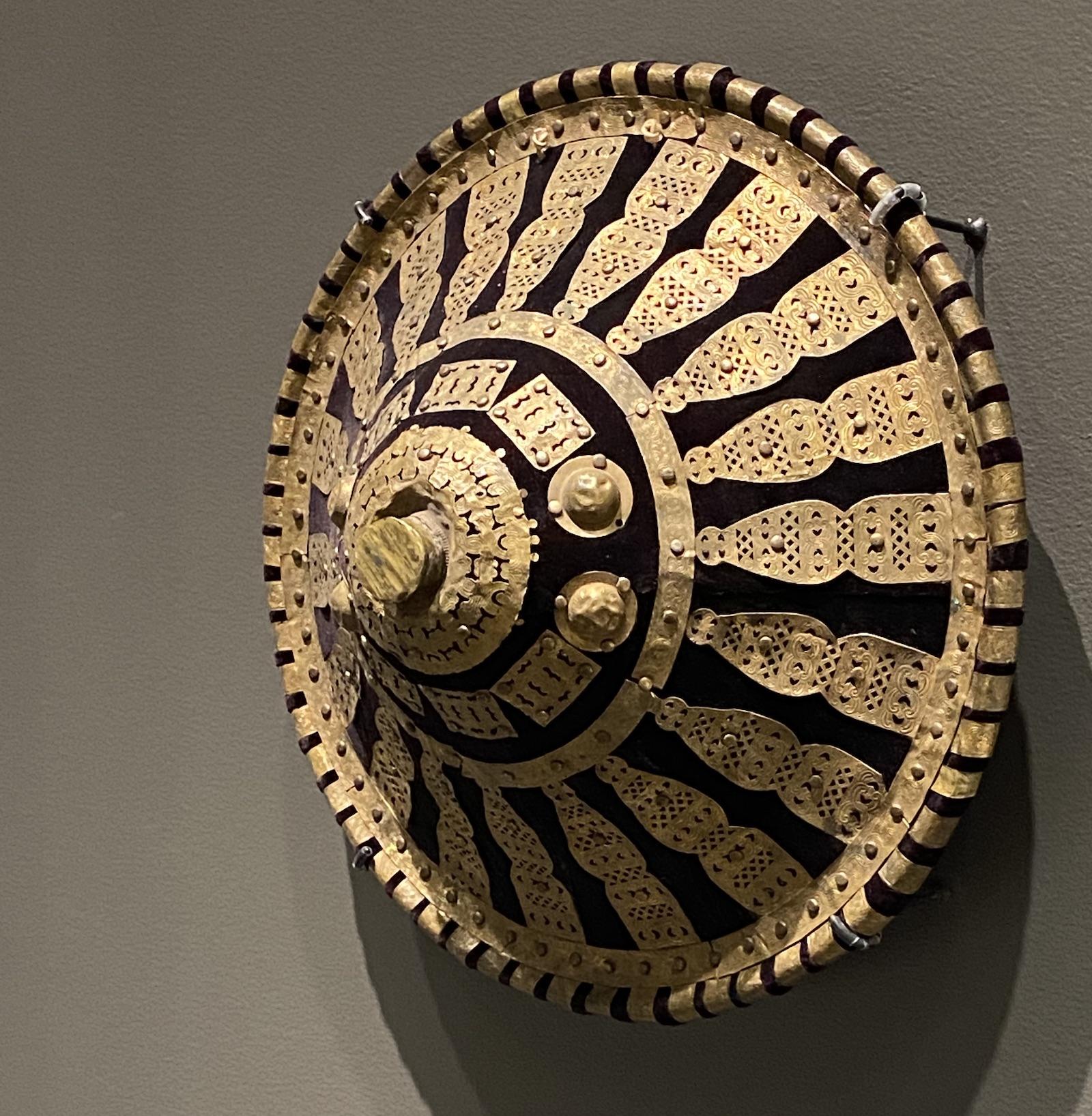 African Metalwork. Ethiopian artist, Ethiopia, Shield, 19th - 20th century. Brass, cloth, and animal hide. Collection of Drs. John and Nicole Dintenfass. Photo by Nia Bowers.