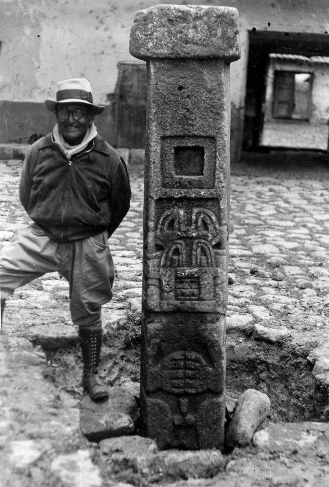 Photo of Peruvian archaeologist Julian C. Tello standing next to the Tello Obelisk, named from his discovery.