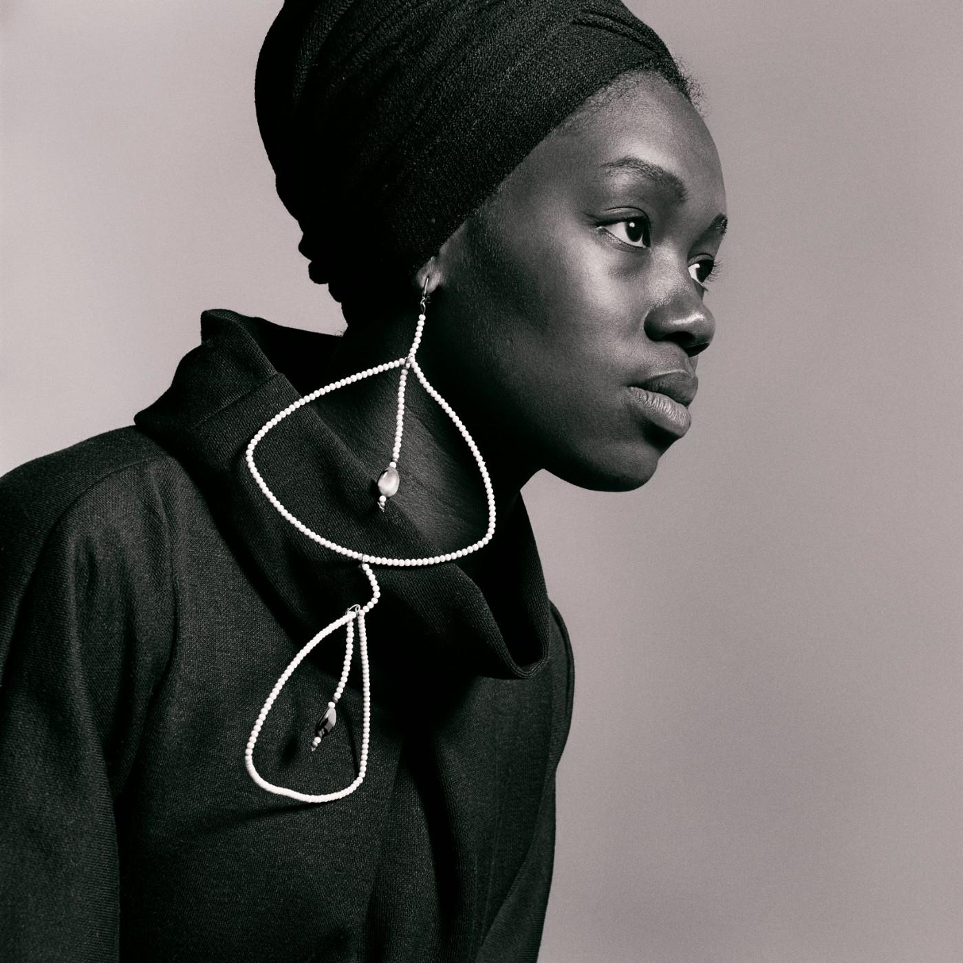 Kwame Brathwaite. Nomsa Brath wearing earrings designed by Carolee Prince, AJASS, Harlem, ca. 1964.