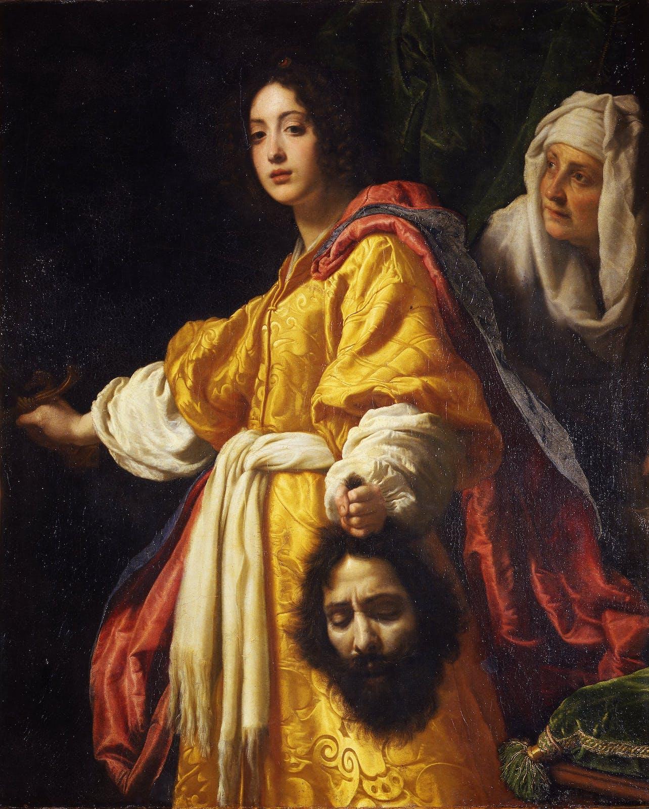 Judith stands with a sword in her right hand and Holofernes’s head in her left. Judith’s maid stands to the left of her, and the blade of the sword is not visible.