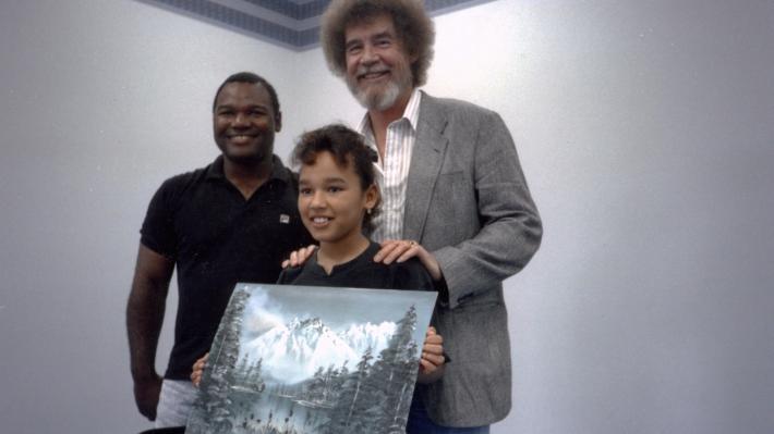 10 Bob Ross- Happy Accidents, Betrayal & Greed - Production Still of Ross with a young student. 