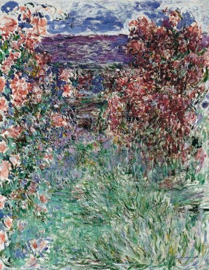 Monet painting of two large rose bushes shrowding the view of a house behind them