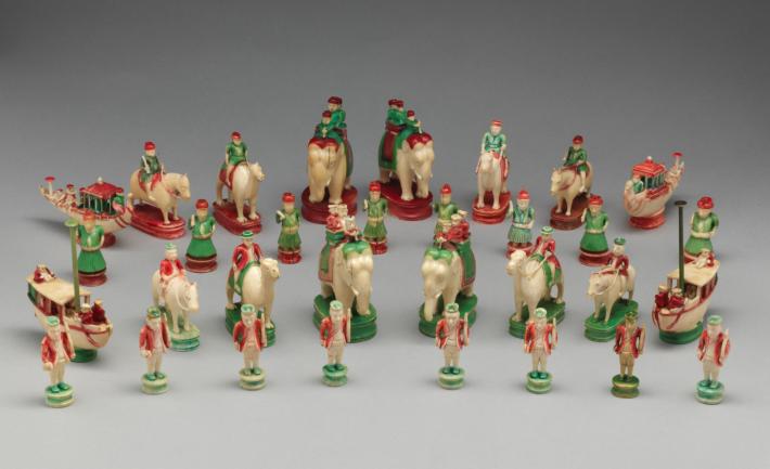 chess set in red and green where figures ride elephants, camels and ships