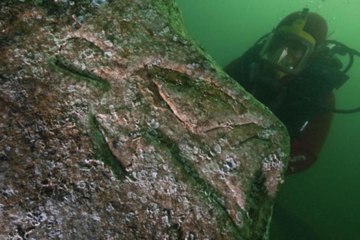 A diver inspects a carved quartzite block in the waters of Alexandria’s Harbor. Credit: Christopher Gerigk.