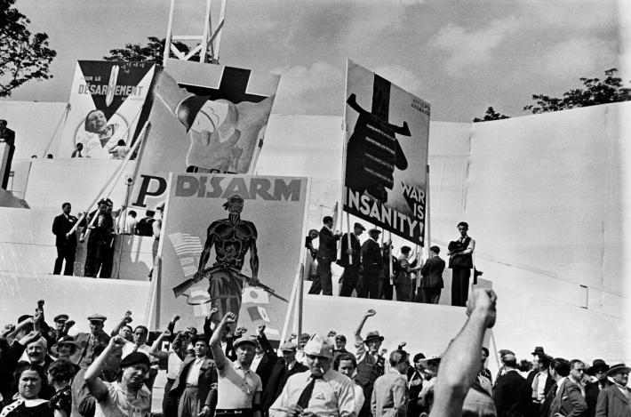 DAVID SEYMOUR black and white photograph of a crowd of people with their fists raised in the air