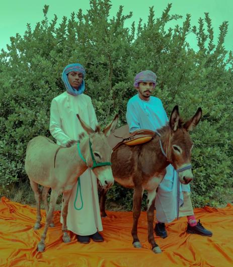 two men with donkeys