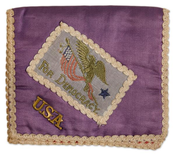 a small purple silk pure with a "USA" pin and a patch reading "for democracy"