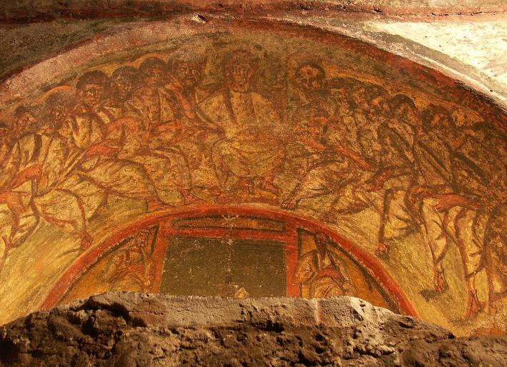 Fresco of Jesus and his Twelve Apostles in the Roman Catacombs of Domitilla.
