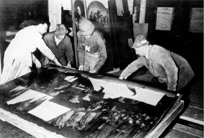 Members of the MFA&A around the Ghent Altarpiece during recovery from the art depot in the Altaussee salt mine, 1945.