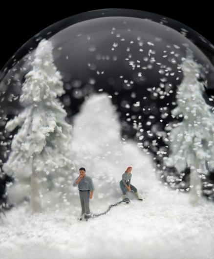 snowglobe with two figures chained together