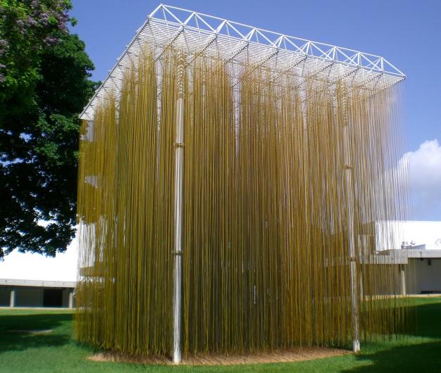 Jesús Rafael Soto Penetrable Amarillo, 1990. Wikimedia Commons. Photo by Guillermo Ramos Flamerich resized. Grid of hanging, yellow strands in massive outdoor, cube installation. 