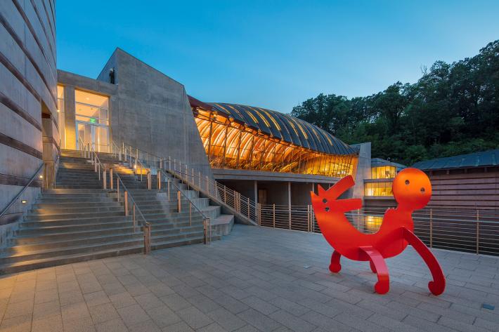 View of restaurant from Walker Landing with "Two-Headed Figure" sculpture by Keith Haring.