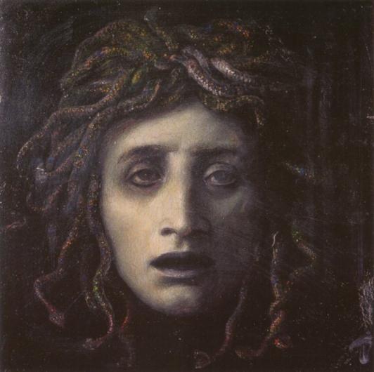 A front-view of Medusa’s face. The colors are gray and muted, and her face is lax.