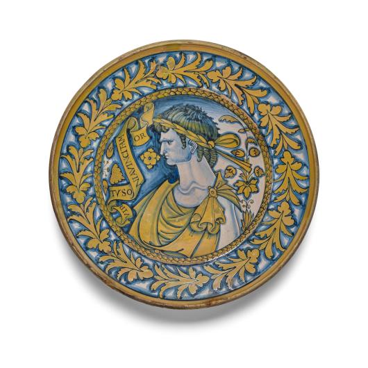 Painted with the portrait of a youth wearing a laurel crown and toga beside a scrolling banner inscribed VIRTVSONIA VINCIT AMOR, the border with a wreath. diameter 16 5/8in (42.3cm)