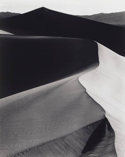 Ansel Adams photograph of black and white sand dunes